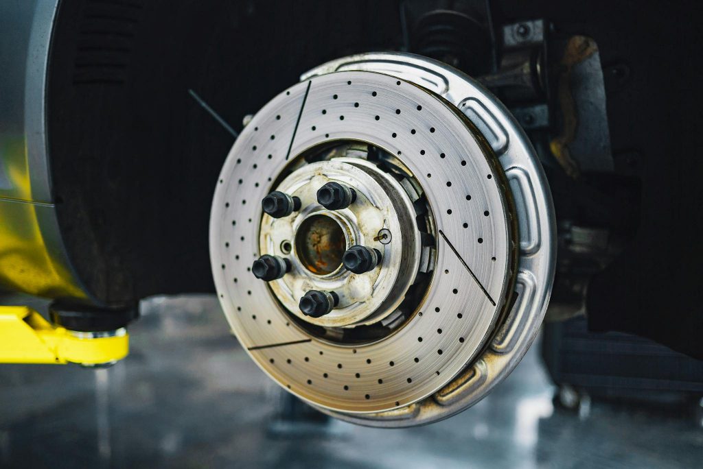 Close-up of a car brake disc showcasing automotive parts and craftsmanship.